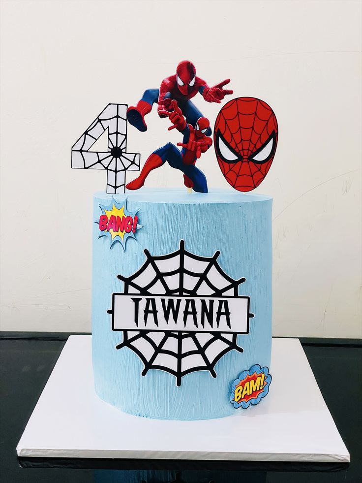 a spiderman cake is decorated with fondant and sprinkles