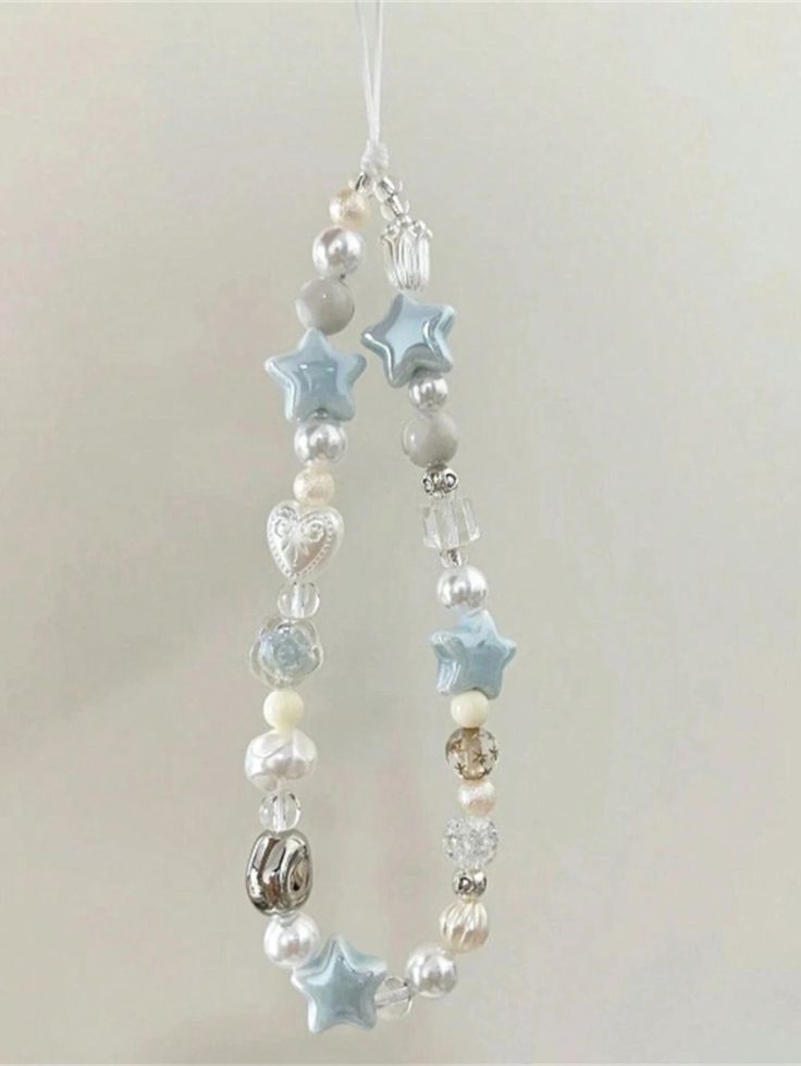 a white and blue beaded ornament hanging from a string