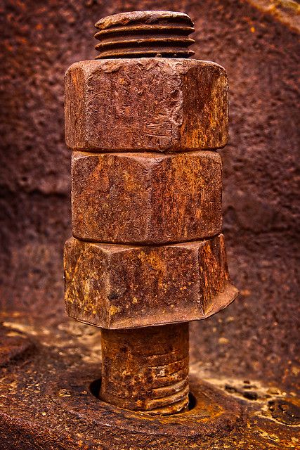 an old rusted metal pipe sticking out of the ground