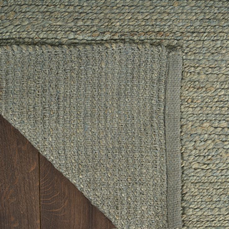 a close up of a rug on top of a wooden floor