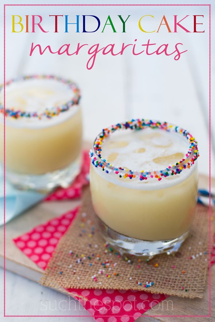 two glasses filled with cake margaritas on top of a table