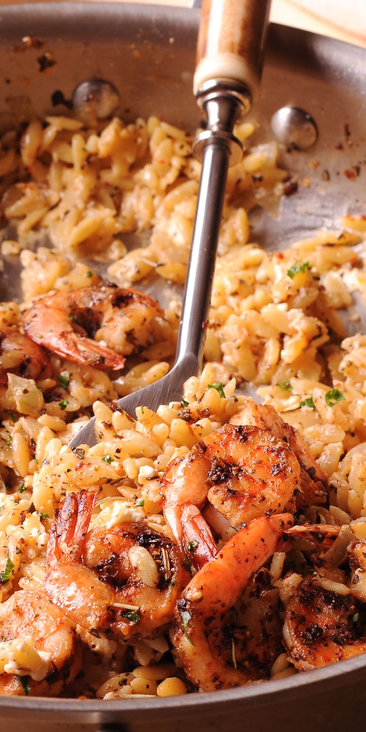 shrimp and rice in a pan with a spatula