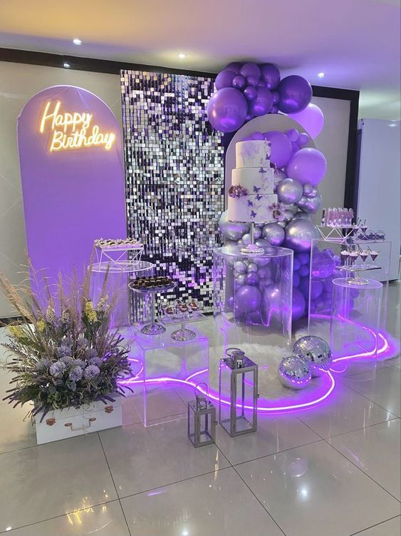 a birthday party with purple balloons and decorations