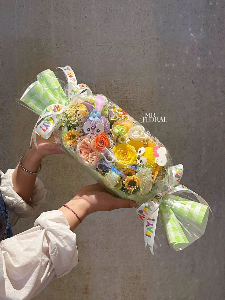 a woman holding a bouquet of flowers in her hand