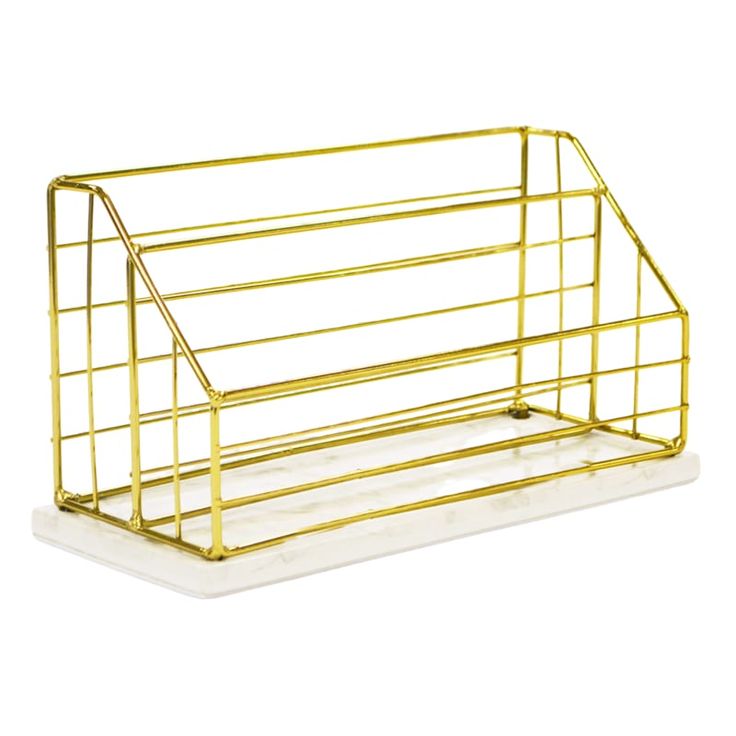 a gold metal magazine rack on a white background