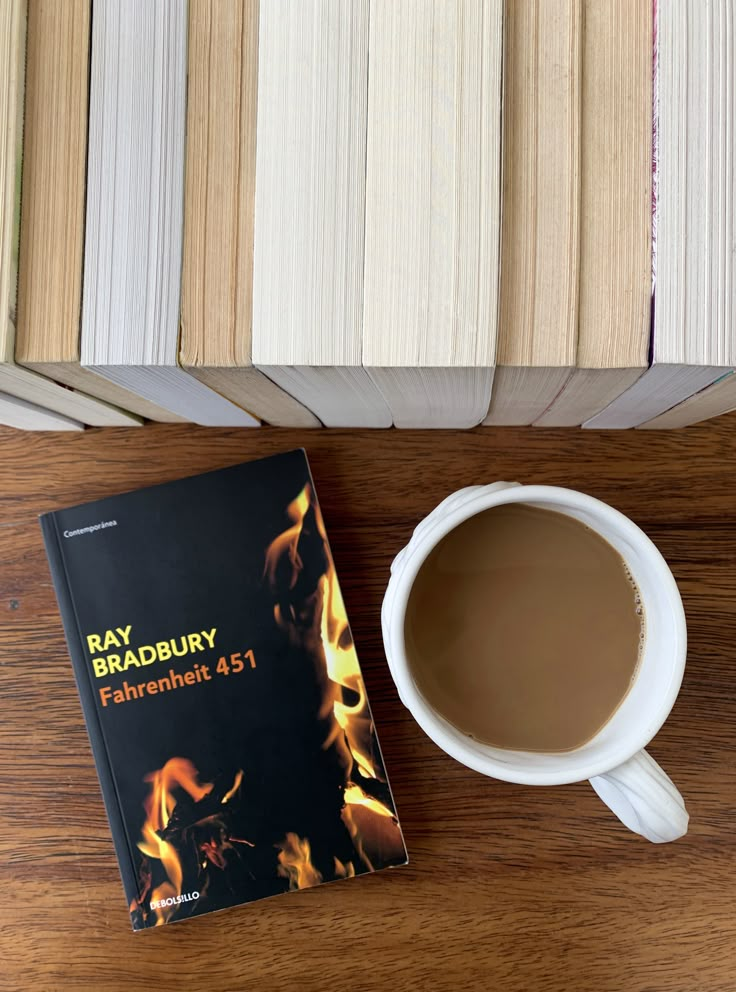 a cup of coffee sitting next to a book