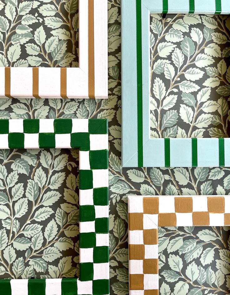 four different frames with green, white and gold designs on the wall next to each other