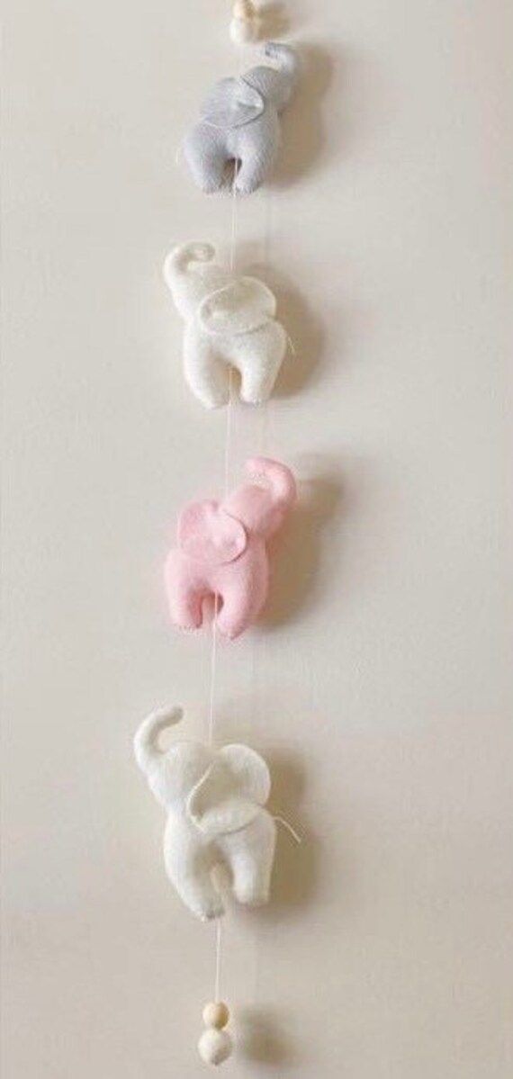 three elephants are hanging on the wall