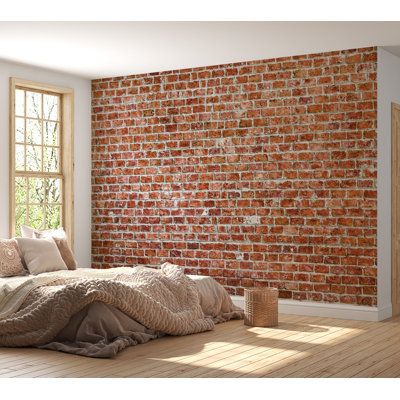 a bedroom with a brick wall and wooden floors