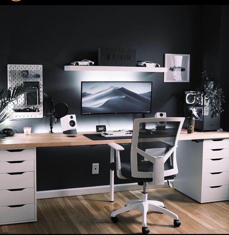 an office with black walls and white furniture