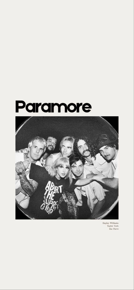 a group of people standing together in front of a black and white poster with the words paramore on it