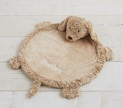 a stuffed animal laying on top of a wooden floor next to a white brick wall