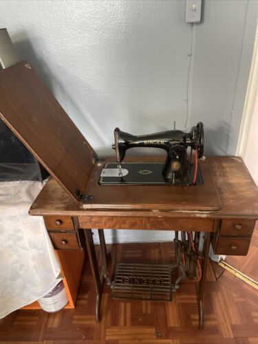 an old sewing machine sitting on top of a wooden table