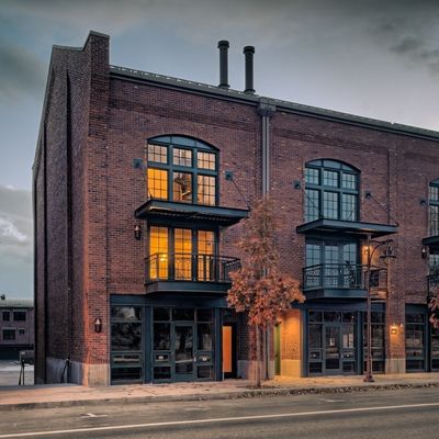 an old brick building with lots of windows and balconies on the second floor