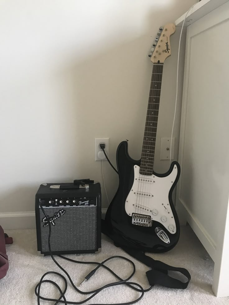 an electric guitar and amp sitting on the floor