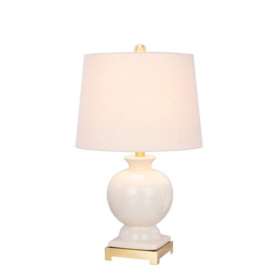 a white table lamp with a gold base and a light shade on the top of it