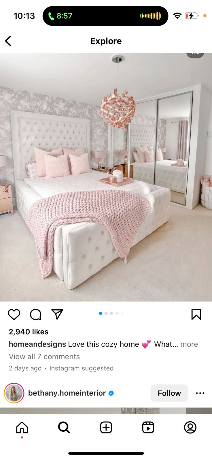 a bed room with a neatly made bed next to a large mirror on the wall