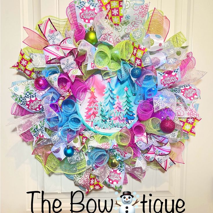 the bowtiquee wreath is decorated with colorful ribbons