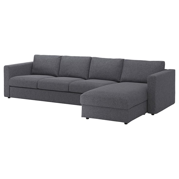 a gray sectional couch sitting on top of a white floor