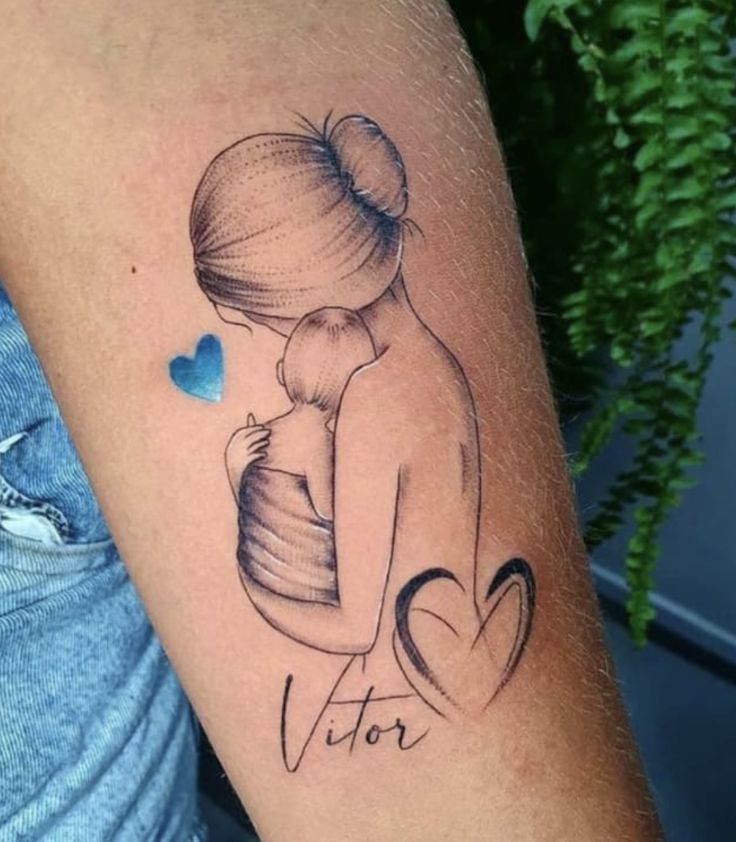 a woman's arm with a tattoo on it that says, victory and a heart