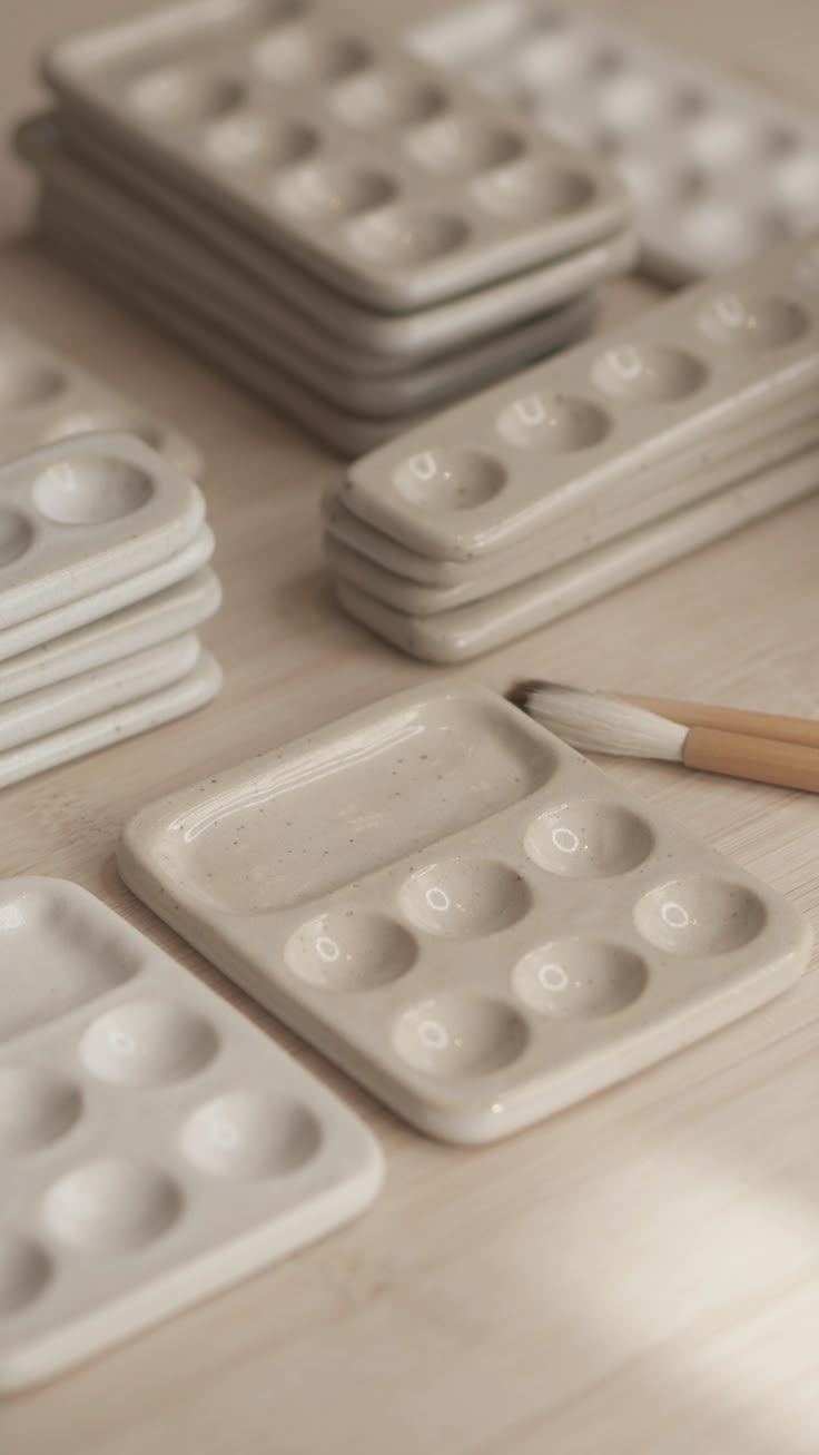 a table topped with lots of white plastic trays