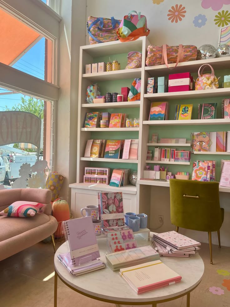 a living room filled with lots of furniture and bookshelves next to a window