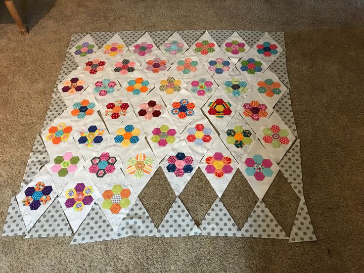 the quilt is laid out on the floor to be made into a wall hanging decoration