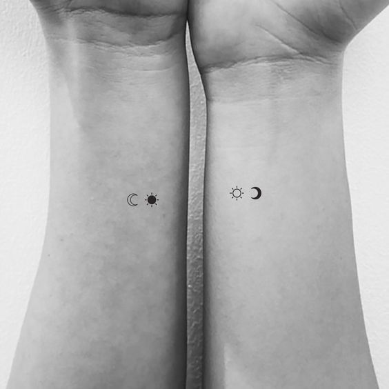 two wrist tattoos with the moon and stars on each one's arm, both showing their