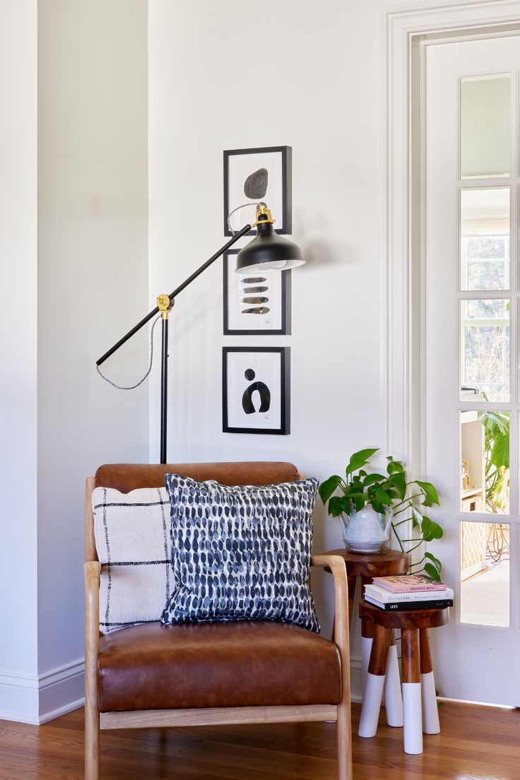 a living room with white walls and wooden floors