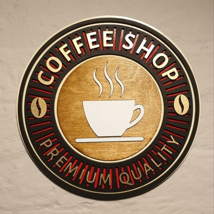 a coffee shop sign hanging on the side of a wall