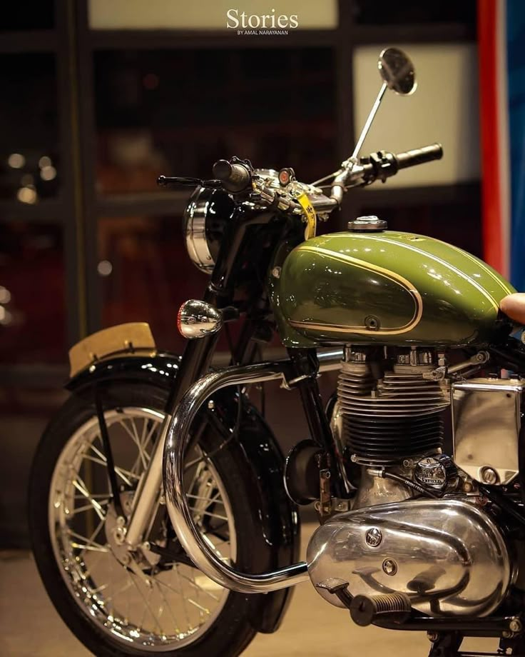 a green motorcycle parked in front of a building