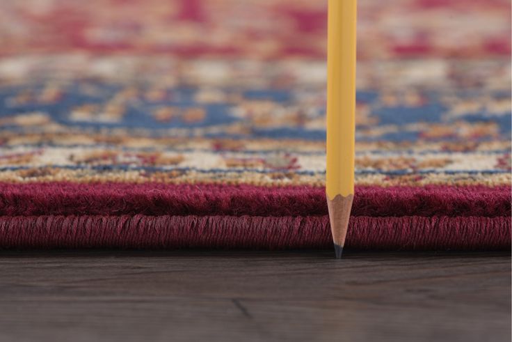 a pencil sticking out of the middle of a rug