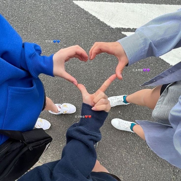 three people making a heart with their hands