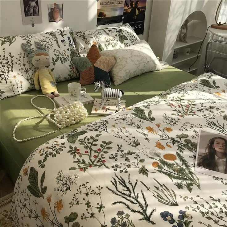 a bed with pillows and pictures on it