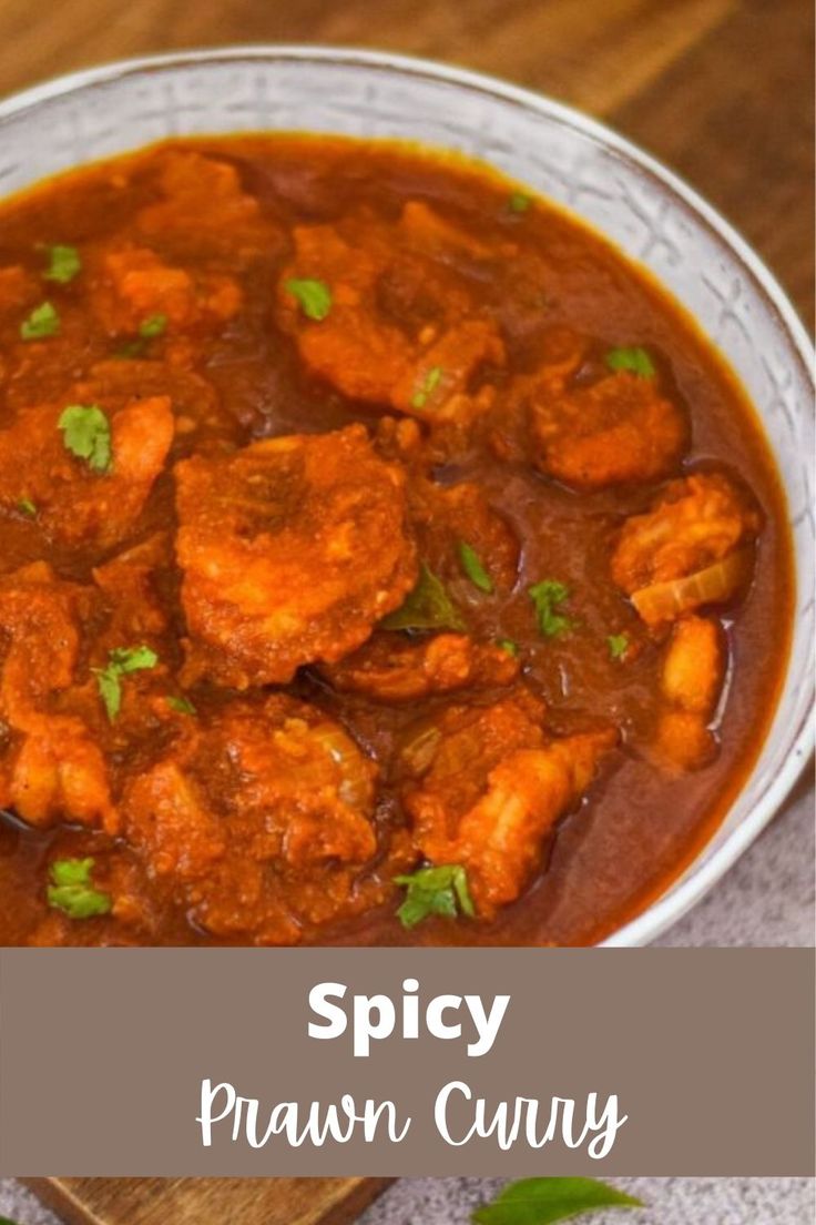 spicy prawn curry in a white bowl on a wooden table