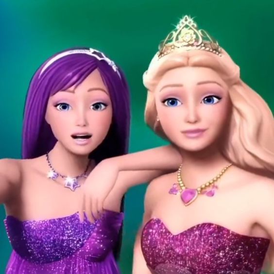 two barbie dolls wearing purple dresses and tiaras, one is pointing at the camera