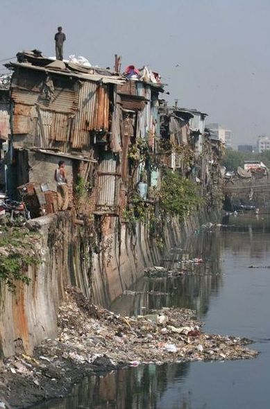 people are standing on the edge of a river