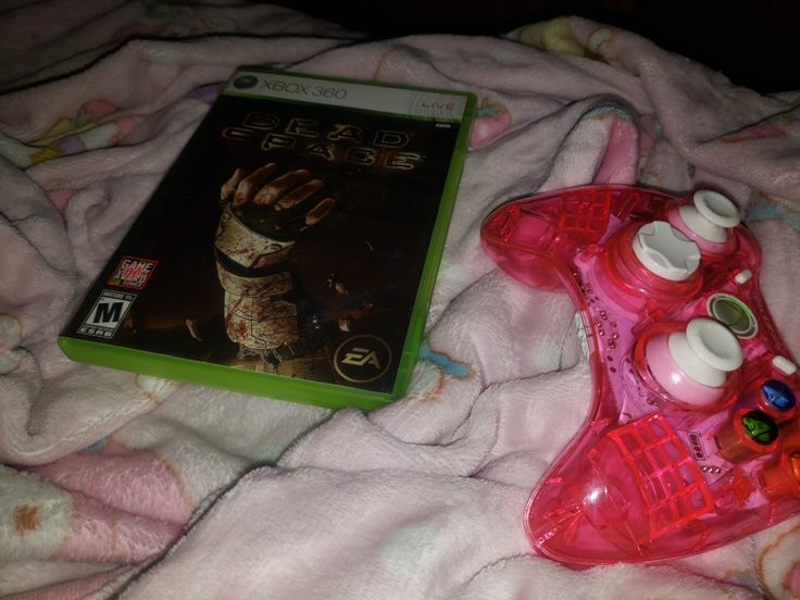 a video game sitting on top of a pink blanket next to a nintendo wii controller