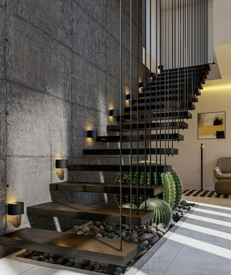 the stairs are made of steel and have glass railings on each side, along with pebbles