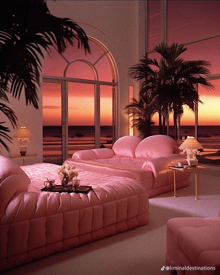 a living room with pink furniture and palm trees