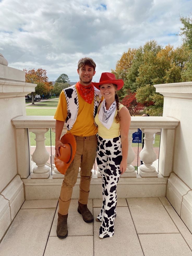 a man and woman dressed up as toy story characters posing for a photo on a balcony