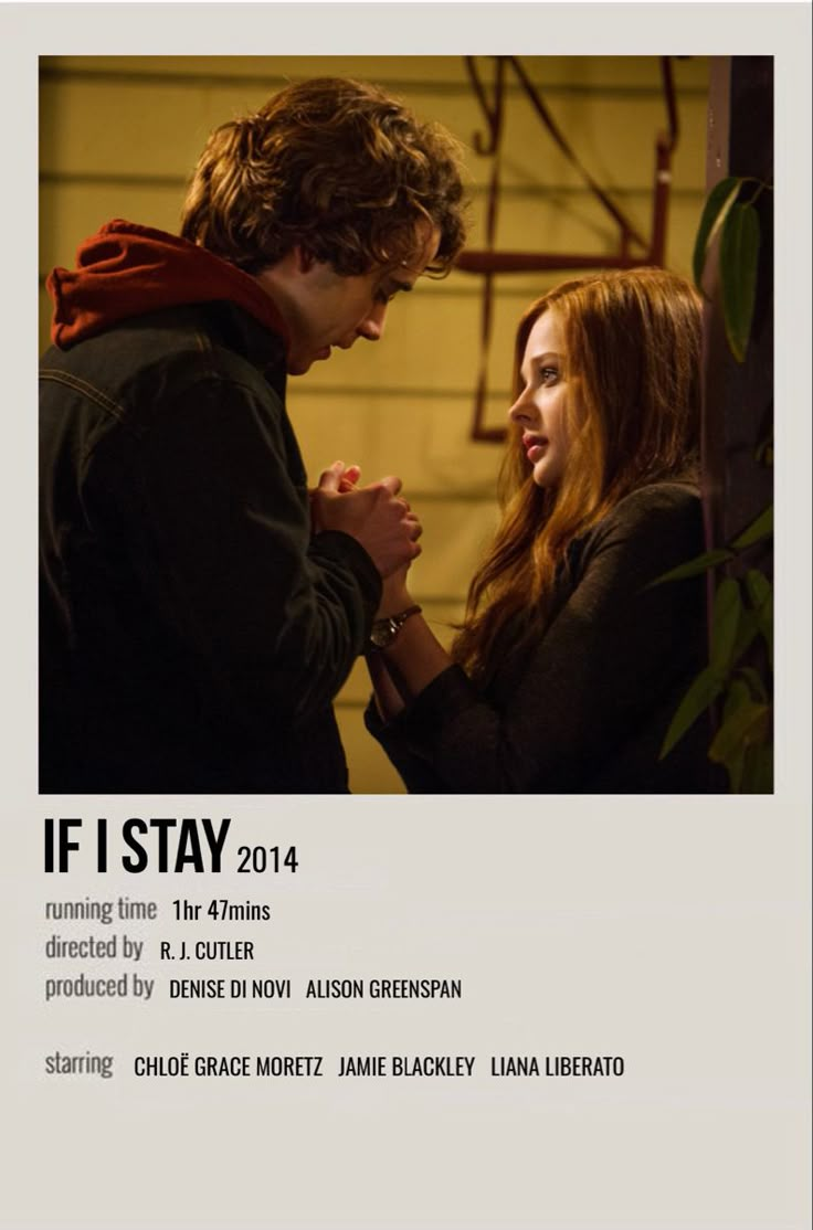 a man and woman standing next to each other in front of a poster for if i stay