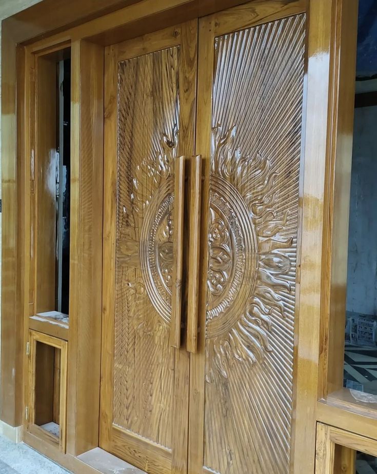 an ornate wooden door with glass inserts