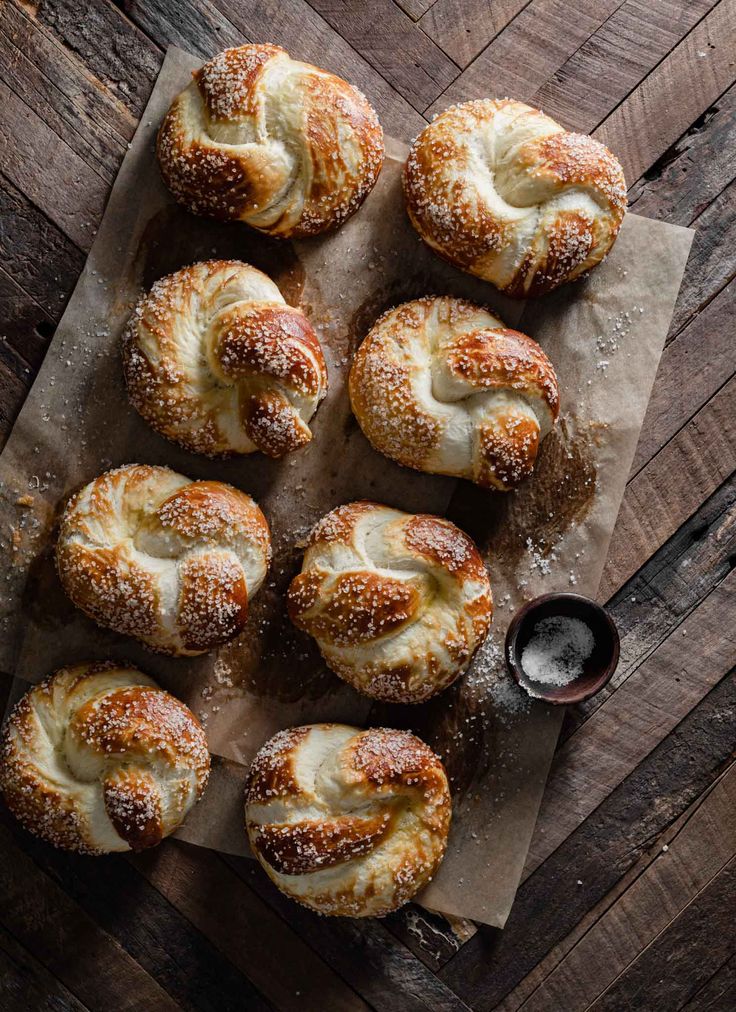 freshly baked bread rolls with butter and powdered sugar on a piece of parchment paper