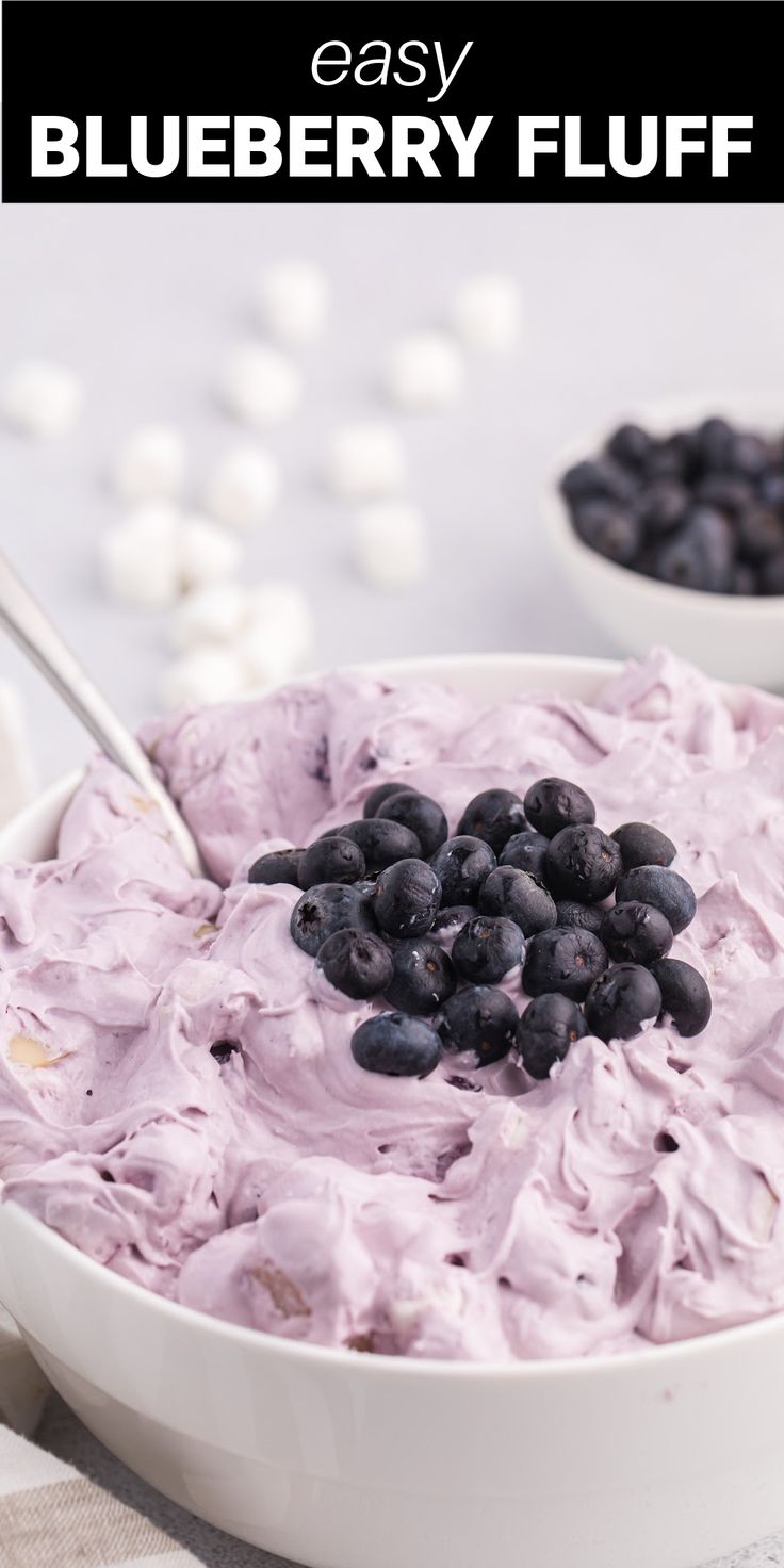 a bowl filled with blueberries and whipped cream