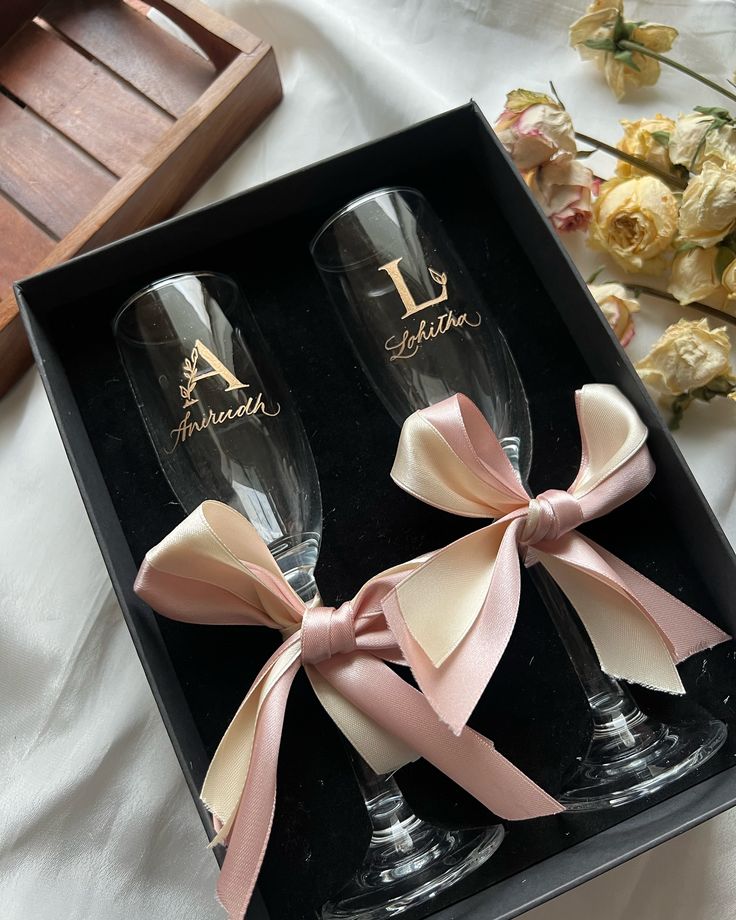 two champagne glasses with bows in a gift box