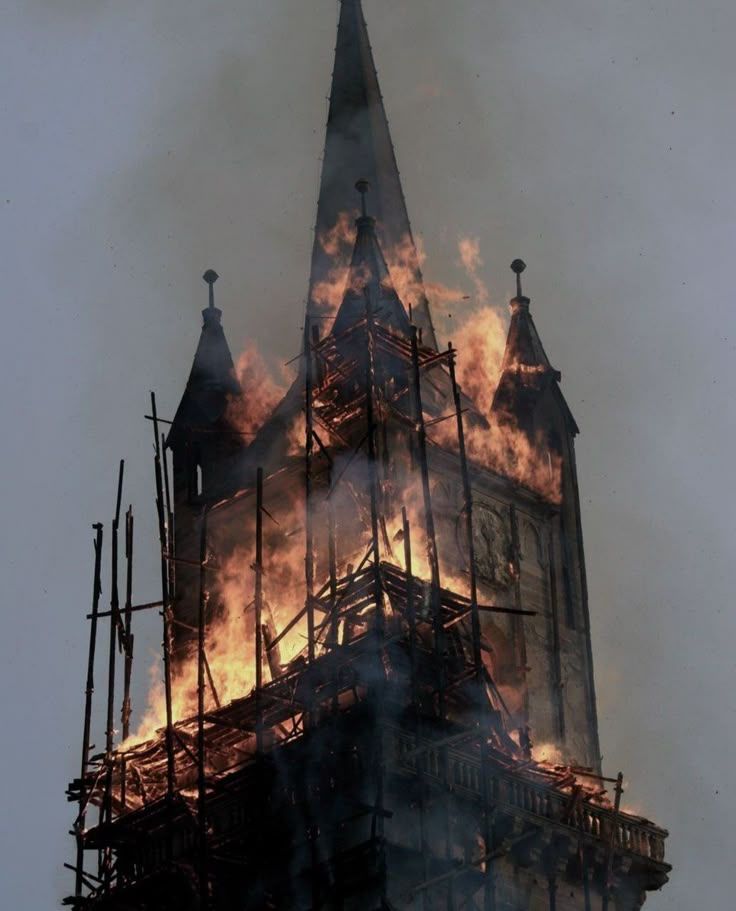 a large clock tower that is on fire