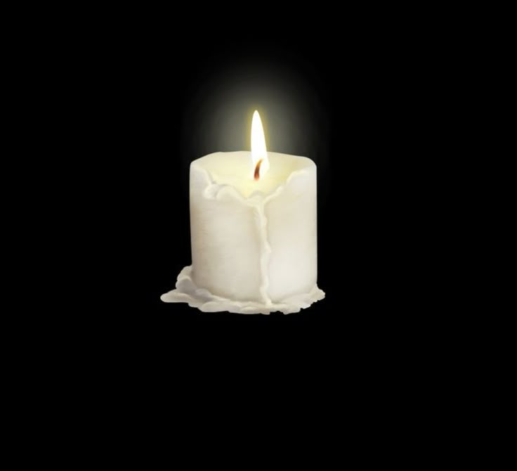 a white candle is lit in the dark