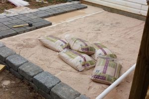 some pillows are laying on the ground in front of a house that is under construction