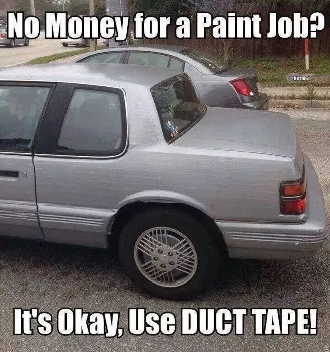 a silver car parked in a parking lot with the caption no money for a paint job? it's okay, use duct tape